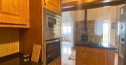 A house with a garden and a restaurant with panoramic views of the ocean and the city.