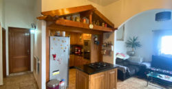 A house with a garden and a restaurant with panoramic views of the ocean and the city.