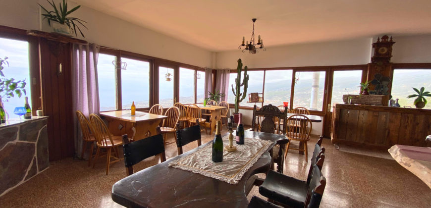 A house with a garden and a restaurant with panoramic views of the ocean and the city.