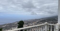 A house with a garden and a restaurant with panoramic views of the ocean and the city.