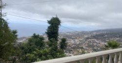 A house with a garden and a restaurant with panoramic views of the ocean and the city.